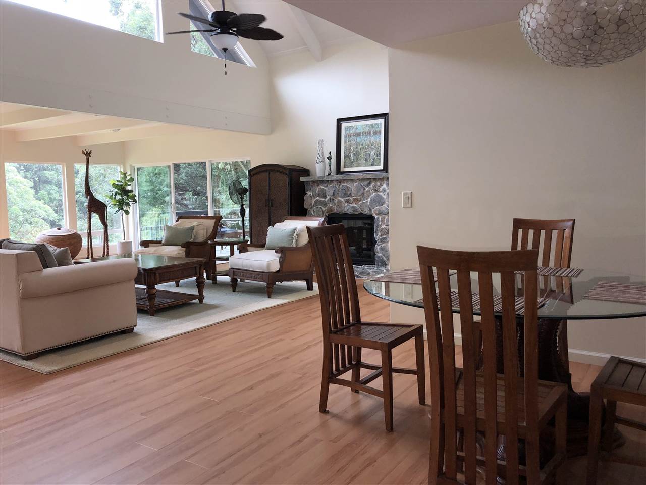 303 Waipalani Road Haiku, HI 96708 - Photo 9 of 29 a living room with furniture a flat screen tv and a large window