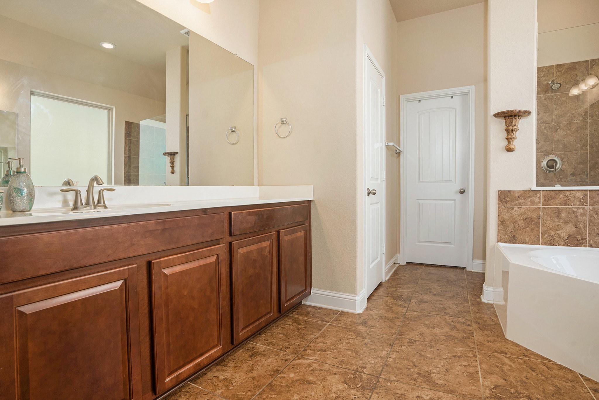 17438 Farm Pasture Trail Hockley, TX 77447 - Photo 18 of 25 a spacious bathroom with a granite countertop sink a mirror and a bathtub