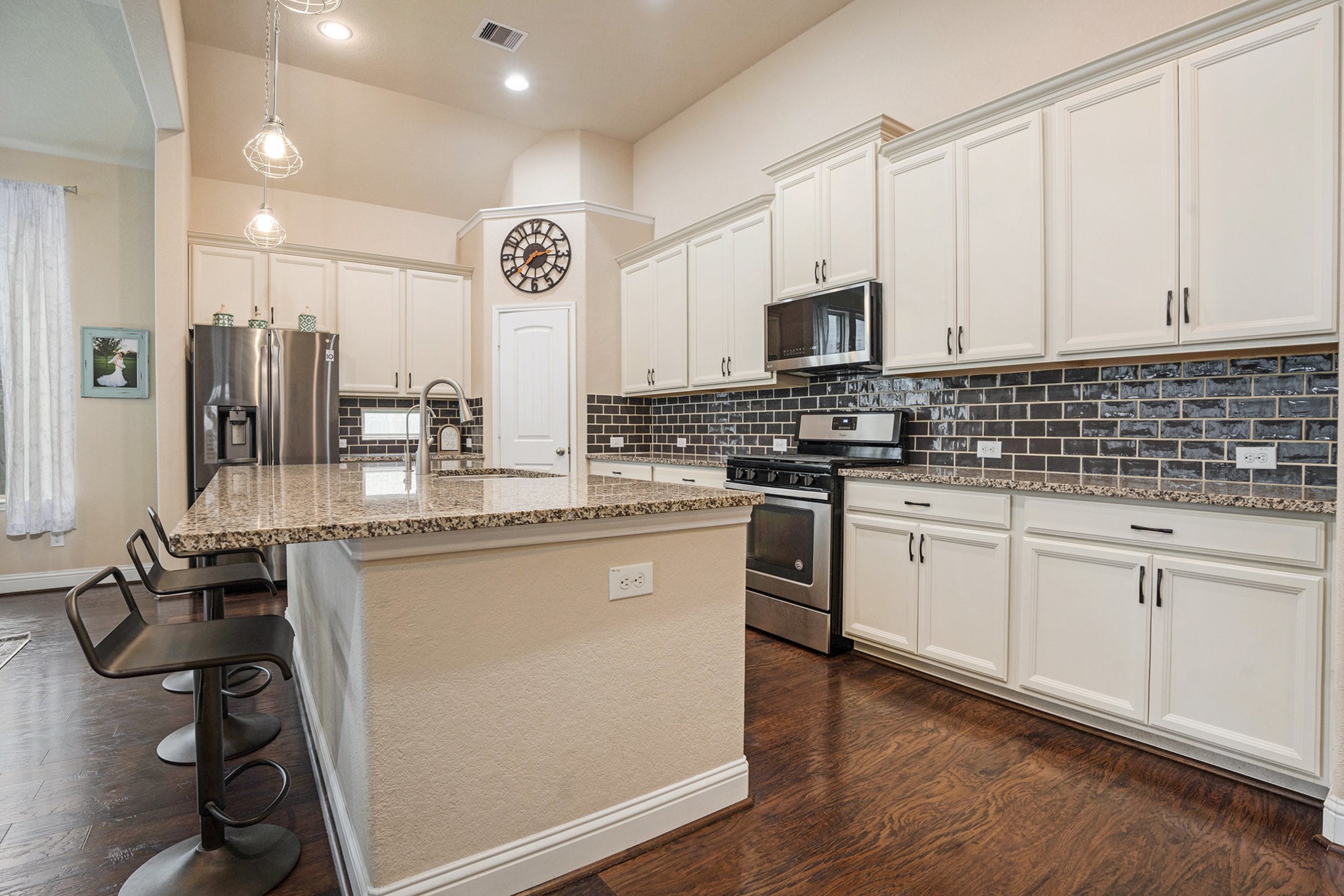 17438 Farm Pasture Trail Hockley, TX 77447 - Photo 10 of 25 a kitchen with stainless steel appliances granite countertop a stove a sink dishwasher and a refrigerator with wooden floor