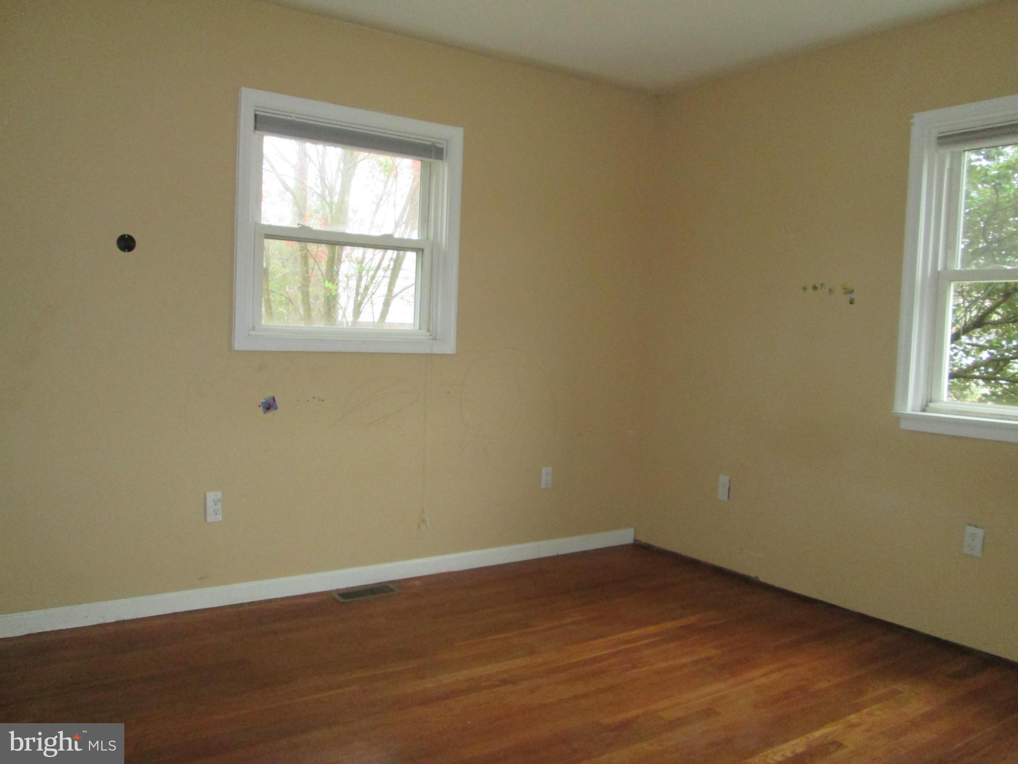 1801 Horner Road Woodbridge, VA 22191 - Photo 7 of 11 a view of an empty room with wooden floor and a window