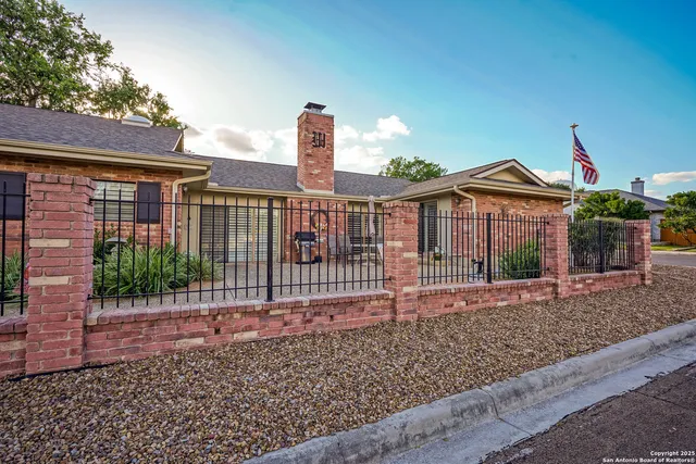 a view of a livingroom with furniture wooden floor and a ceiling fan