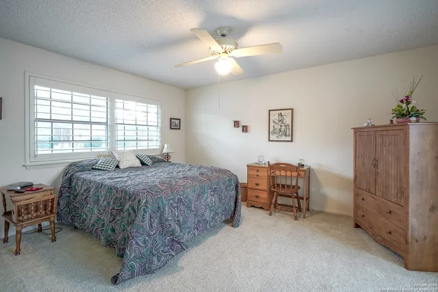 a bed sitting in a bedroom next to a window