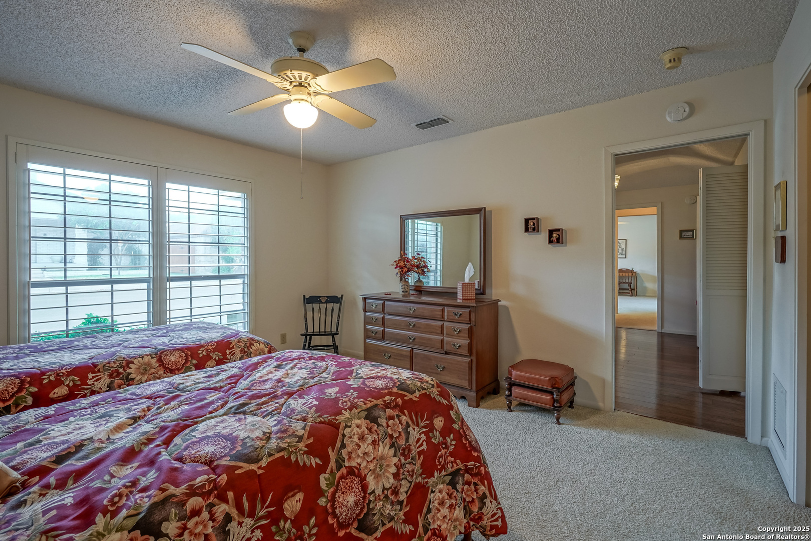 6118 Crescent Falls Windcrest, TX 78239 - Photo 23 of 60 a bedroom with a bed and a chandelier
