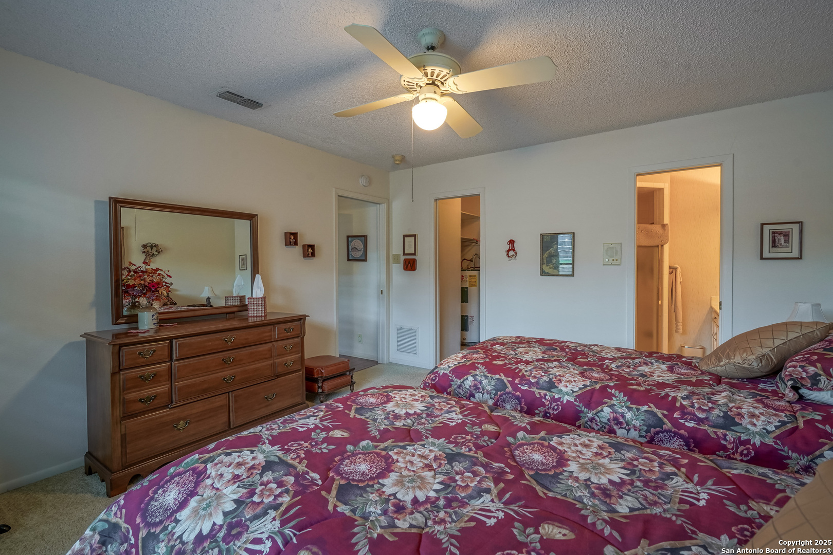 6118 Crescent Falls Windcrest, TX 78239 - Photo 24 of 60 a bedroom with a bed and a chandelier
