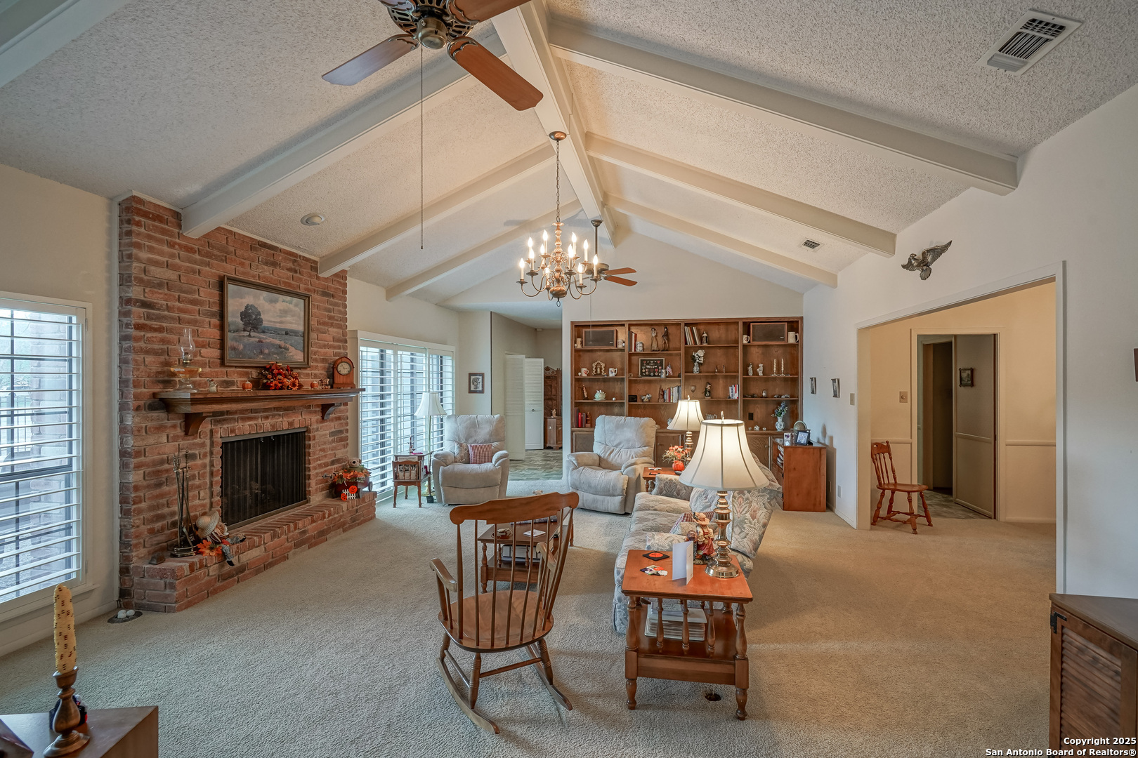 6118 Crescent Falls Windcrest, TX 78239 - Photo 27 of 60 a dining room with furniture a fireplace and chandelier