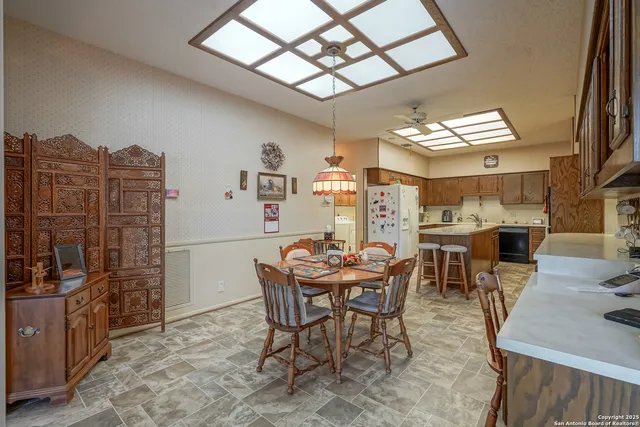 a kitchen with stainless steel appliances granite countertop a sink stove and microwave