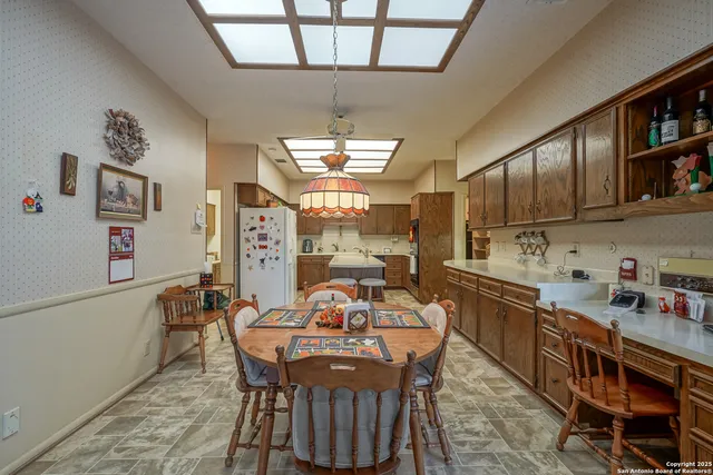 a kitchen with a sink a counter and chairs