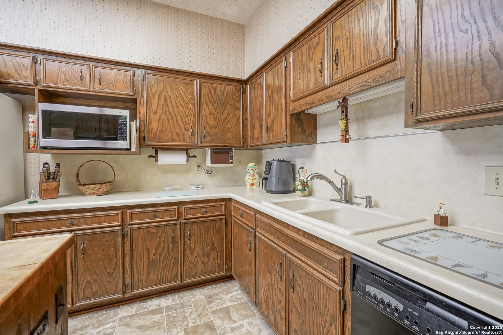 6118 Crescent Falls Windcrest, TX 78239 - Photo 40 of 60 a kitchen with stainless steel appliances granite countertop a sink stove and microwave