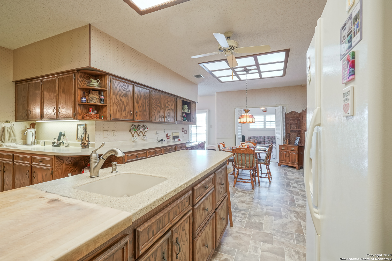 6118 Crescent Falls Windcrest, TX 78239 - Photo 42 of 60 a kitchen with a sink a counter and chairs