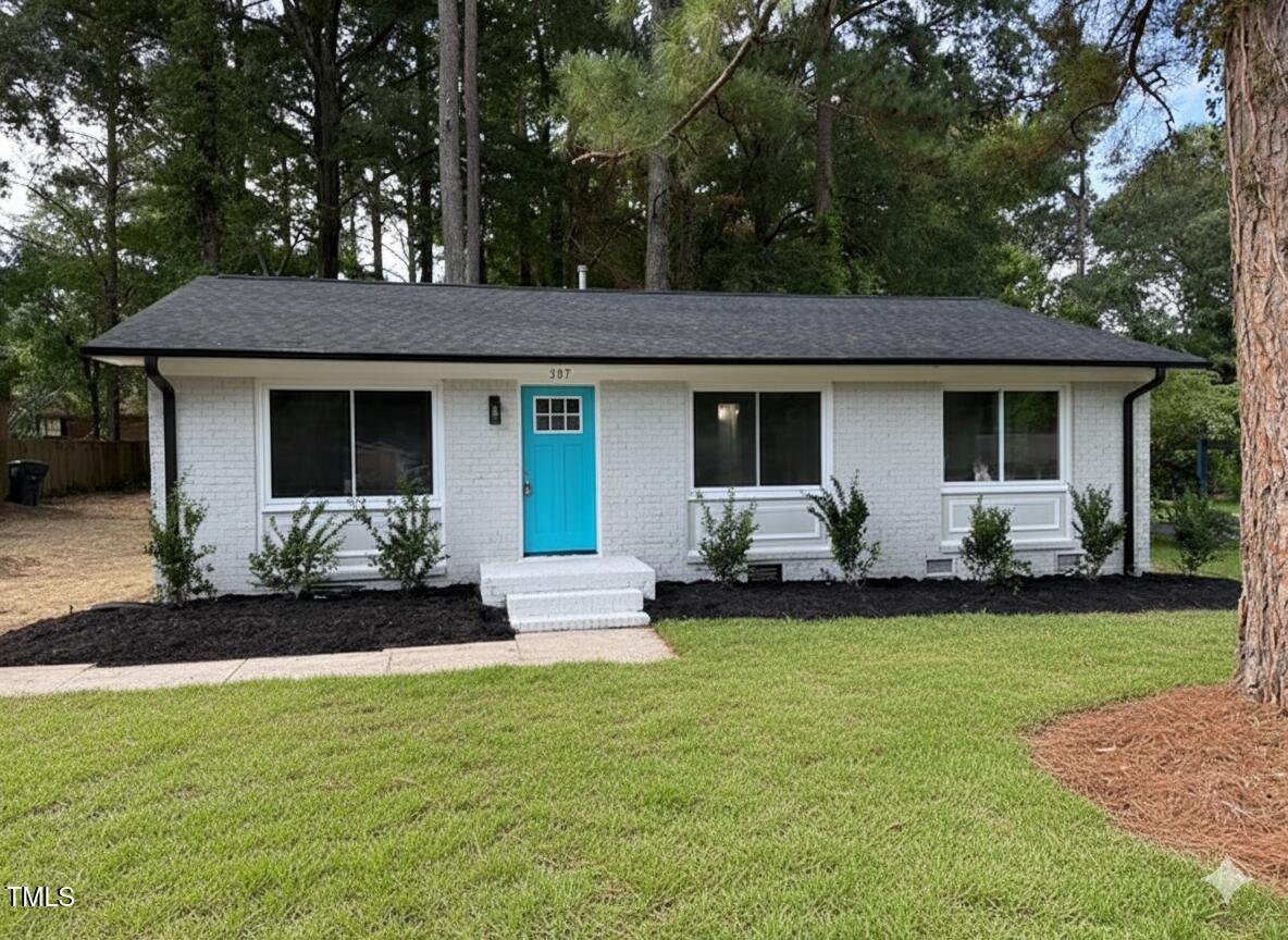 a front view of house with yard and green space