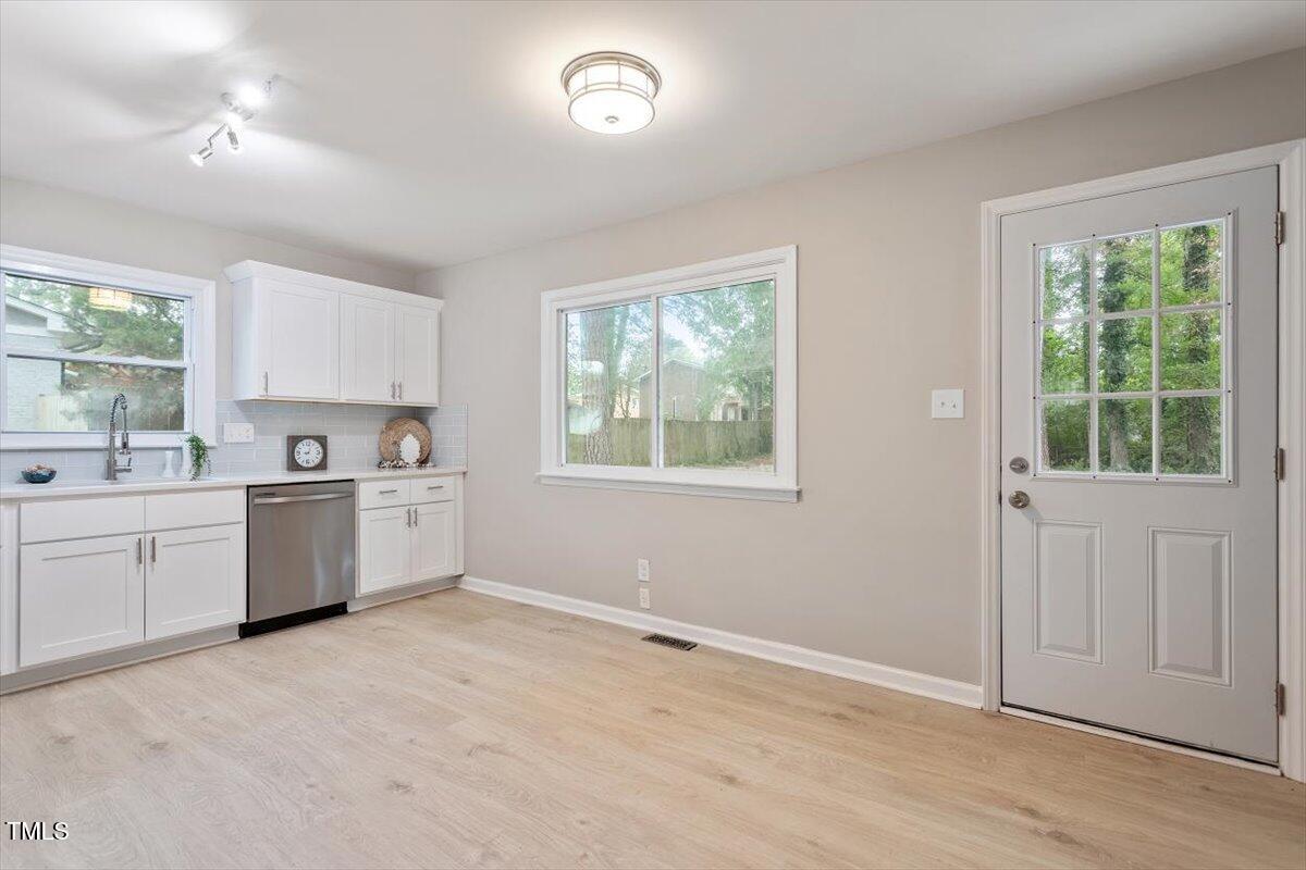 507 Forest Ridge Road Garner, NC 27529 - Photo 16 of 33 a kitchen with a stove a sink and a window