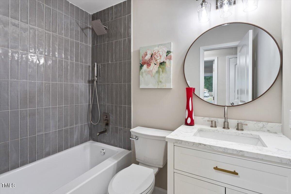507 Forest Ridge Road Garner, NC 27529 - Photo 22 of 33 a bathroom with a sink toilet and shower