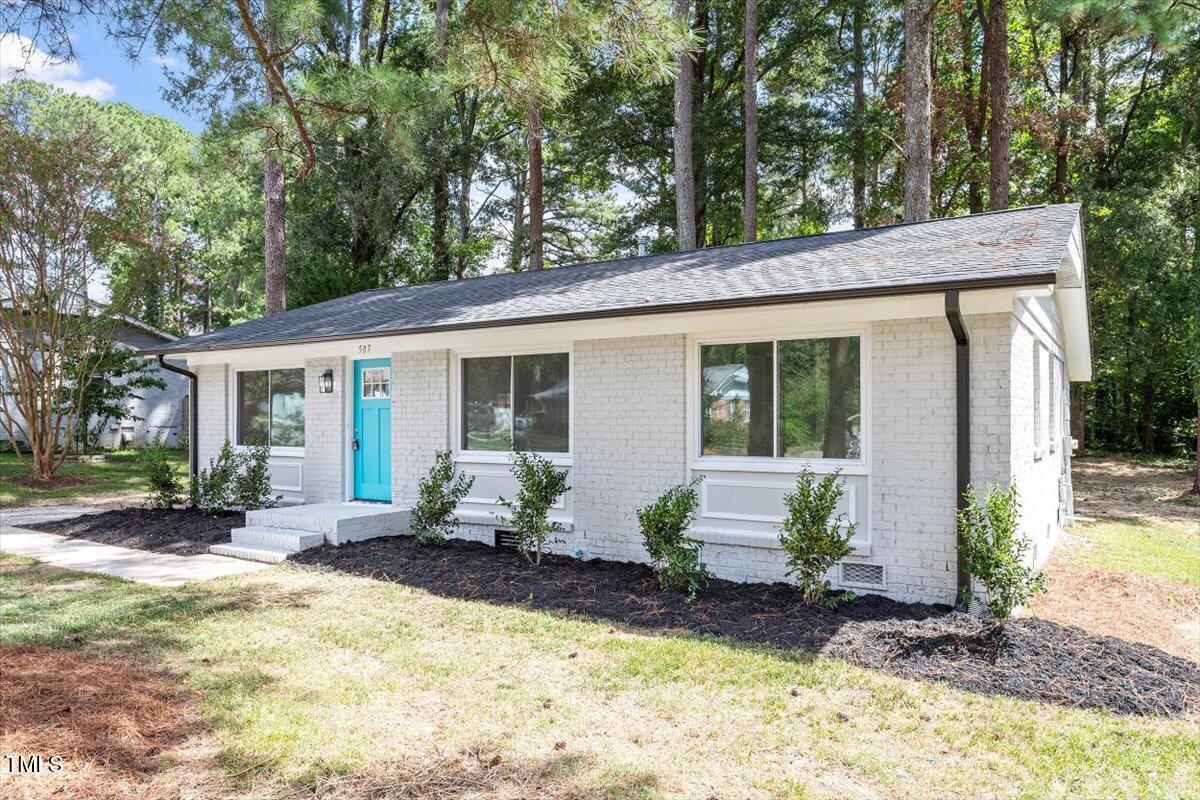 507 Forest Ridge Road Garner, NC 27529 - Photo 24 of 33 a front view of house with yard and seating area