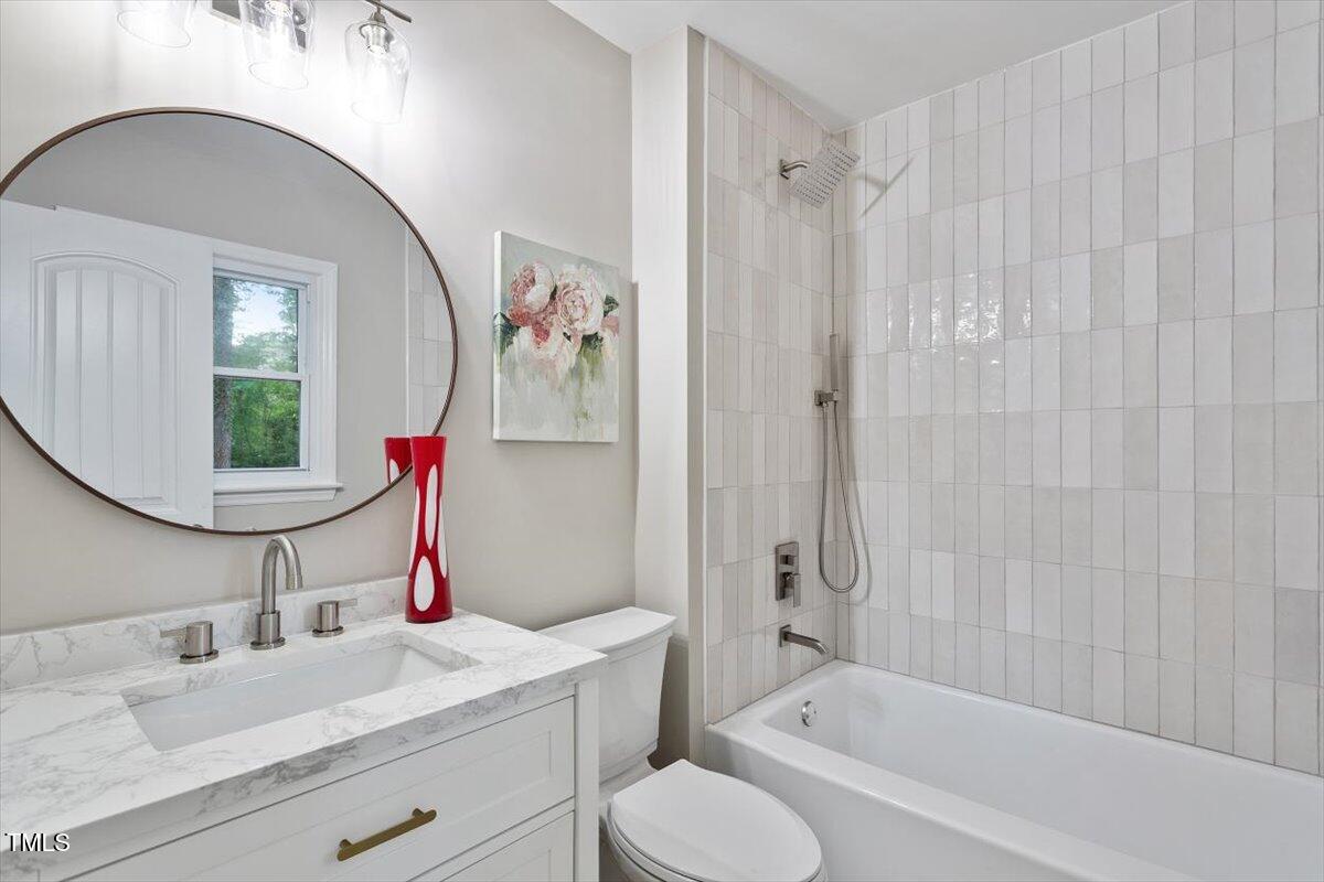 507 Forest Ridge Road Garner, NC 27529 - Photo 3 of 33 a bathroom with a granite countertop sink mirror vanity and toilet