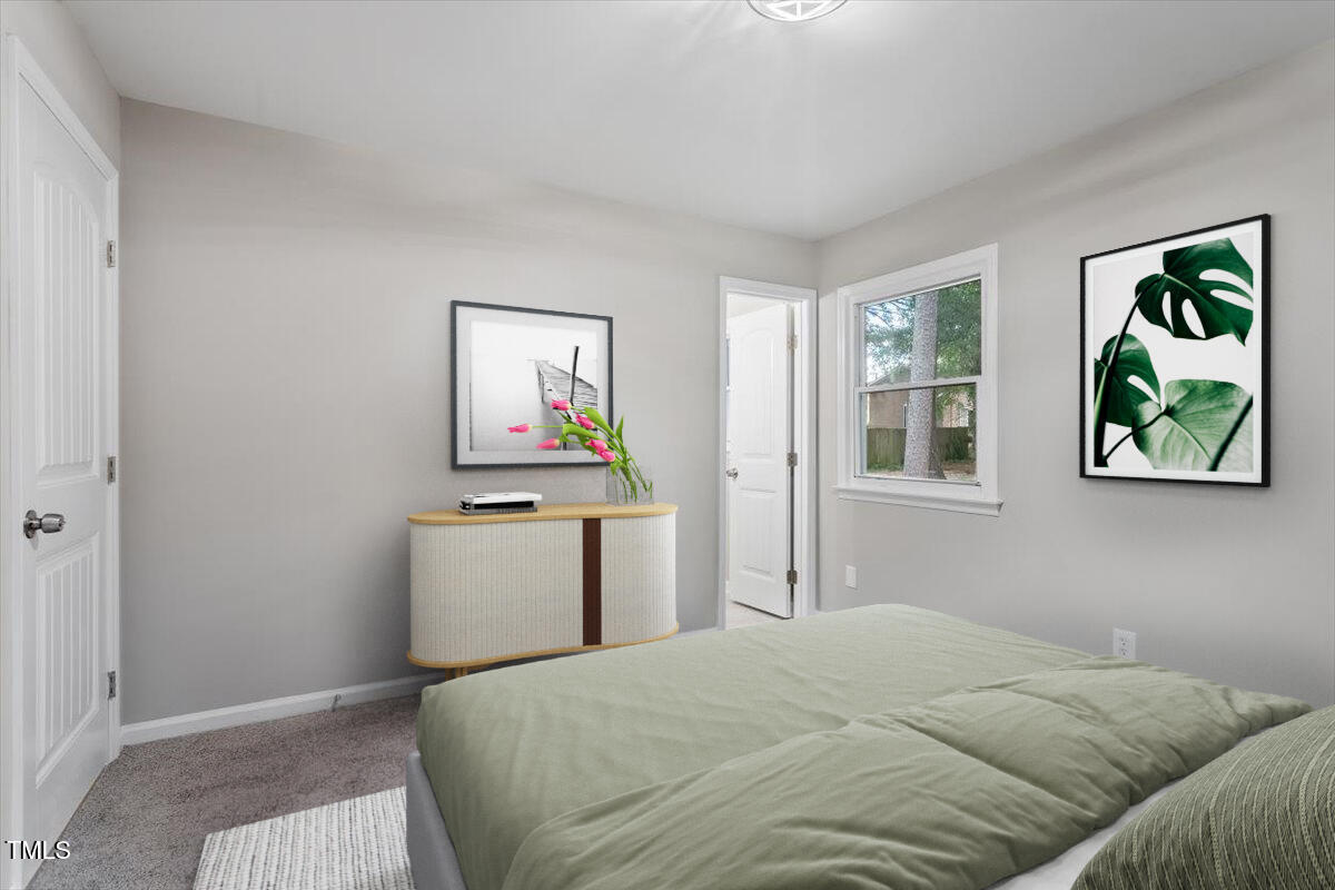 507 Forest Ridge Road Garner, NC 27529 - Photo 9 of 33 a bedroom with a bed and a window