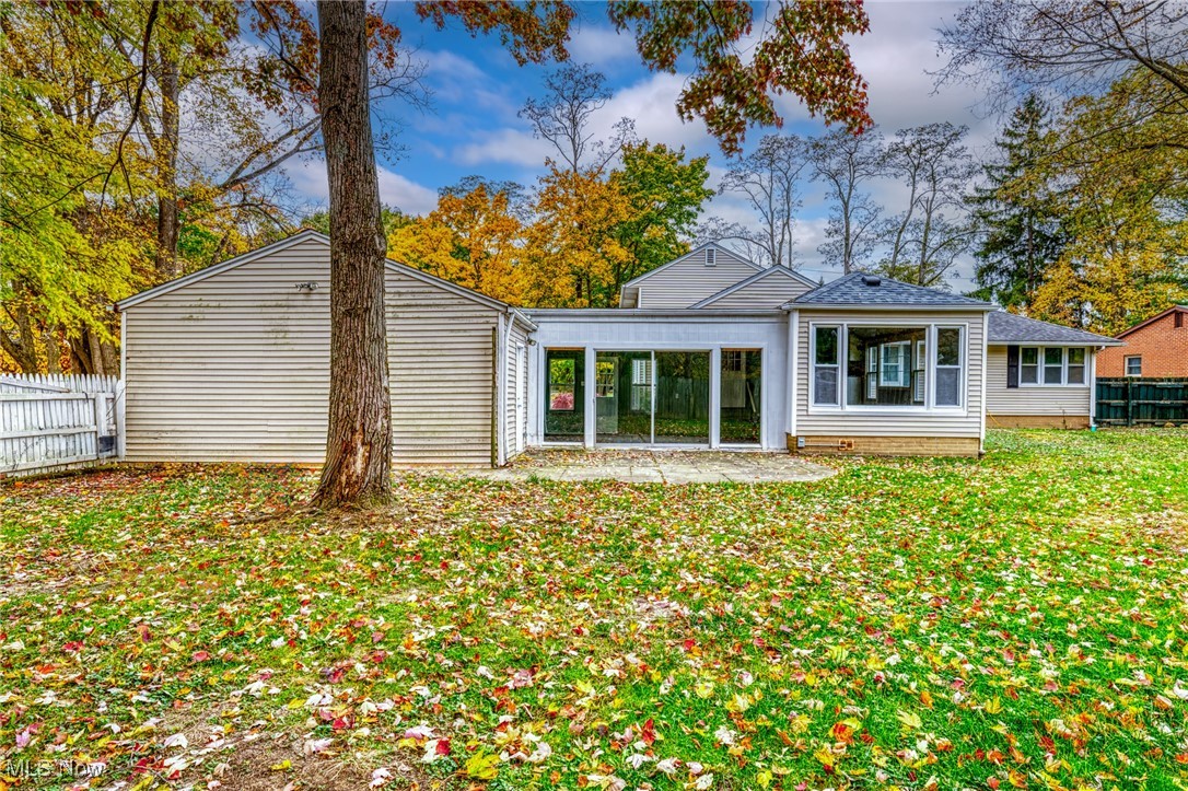 Back of house with a yard