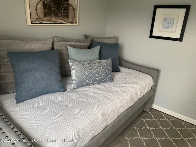 a bedroom with a bed and painting on the wall