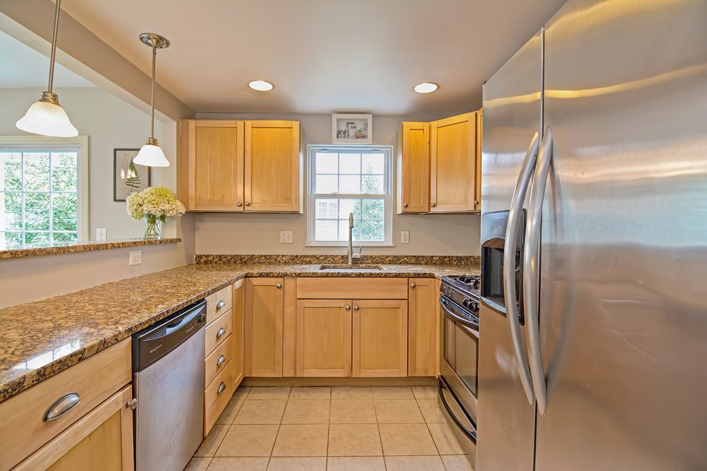 43 Turtle Brook Road, Unit 43 Canton, MA 02021 - Photo 7 of 28 a kitchen with stainless steel appliances granite countertop a sink and a refrigerator