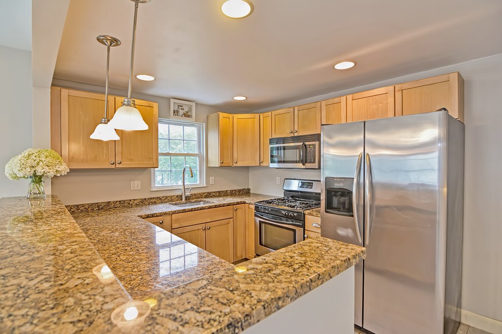 43 Turtle Brook Road, Unit 43 Canton, MA 02021 - Photo 9 of 28 a kitchen with stainless steel appliances granite countertop a sink a stove and refrigerator