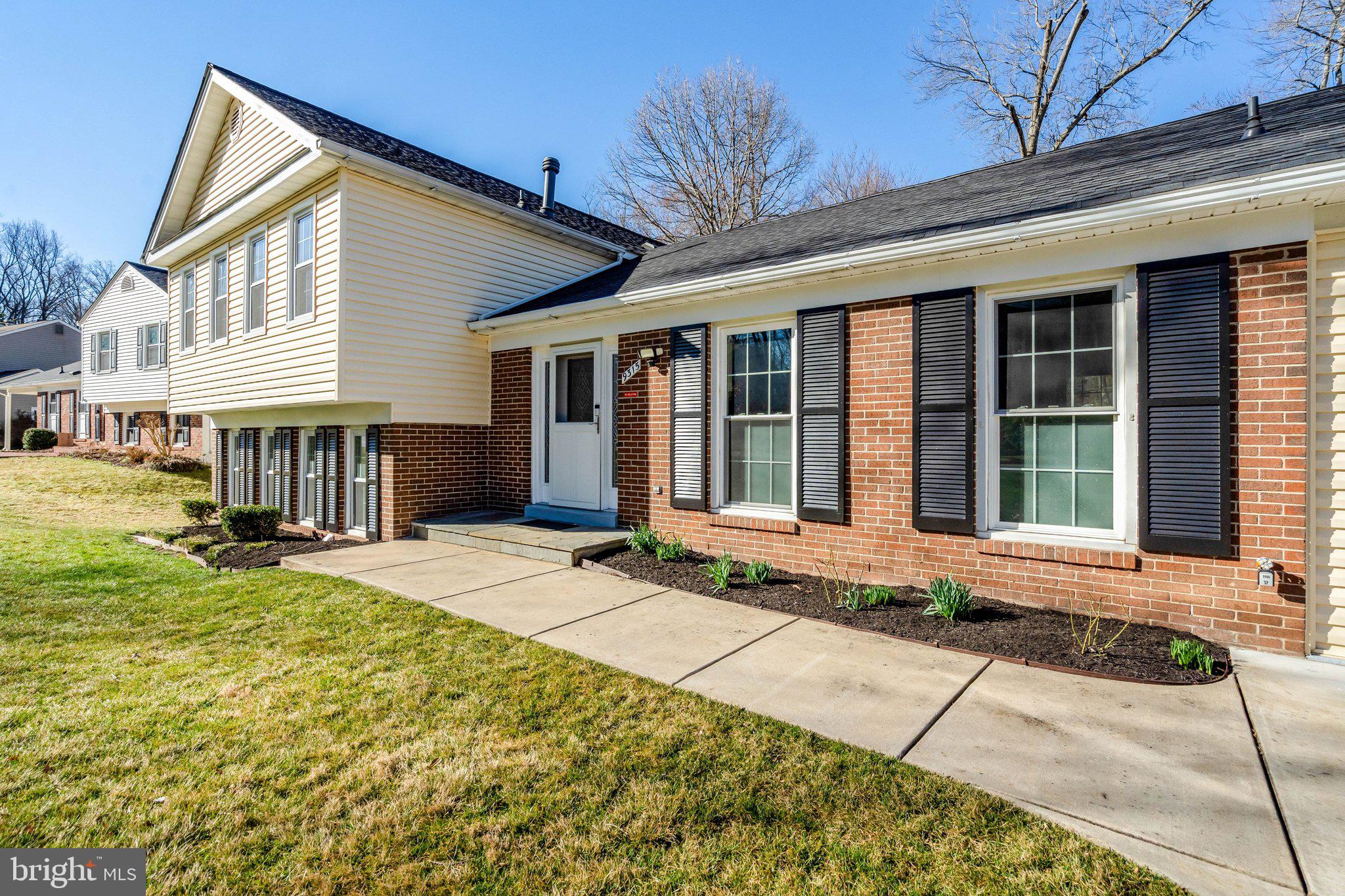 a front view of a house with a garden and porch