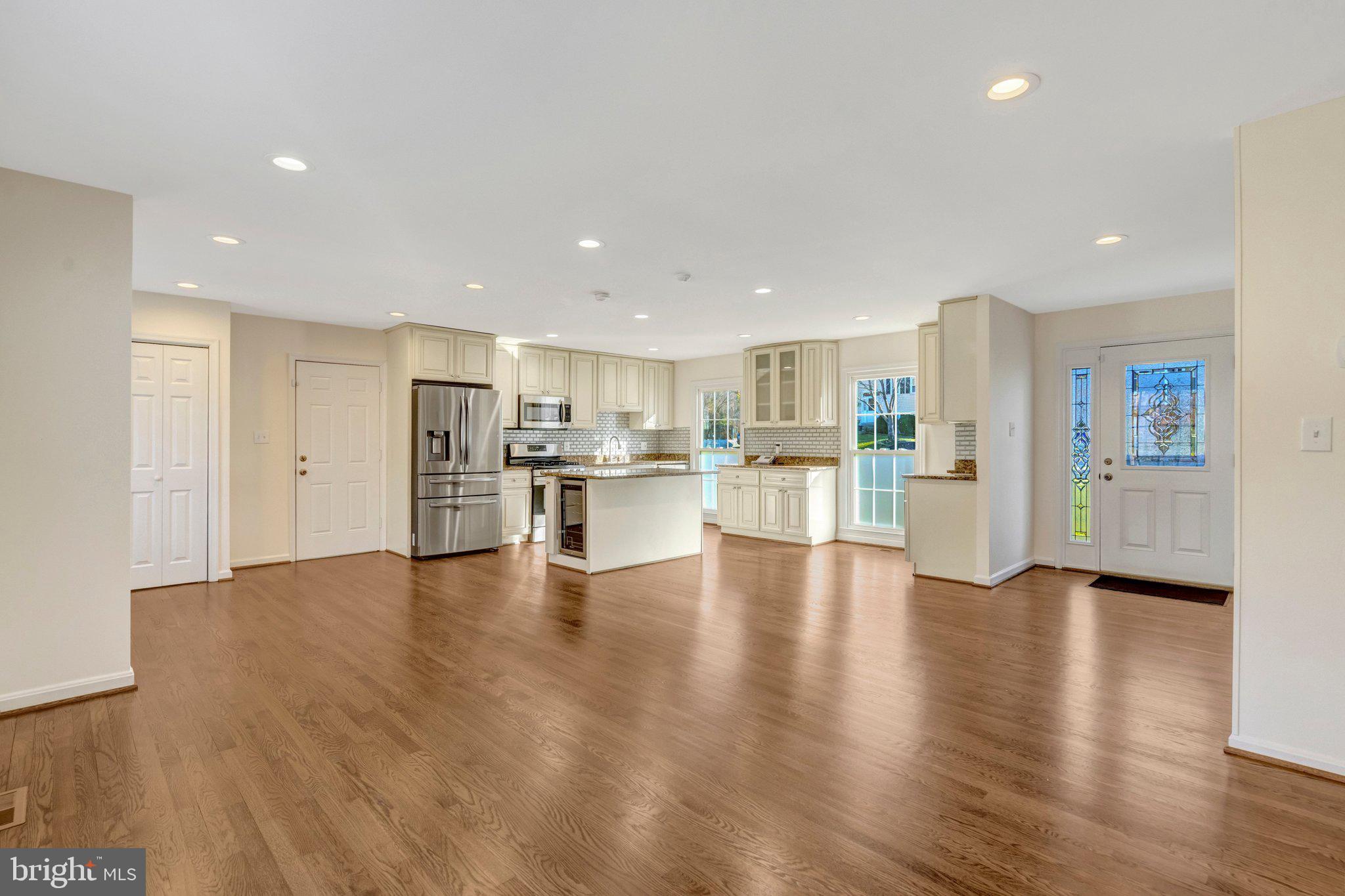 9315 Winbourne Road Burke, VA 22015 - Photo 14 of 51 a view of kitchen dining table chairs microwave and cabinets