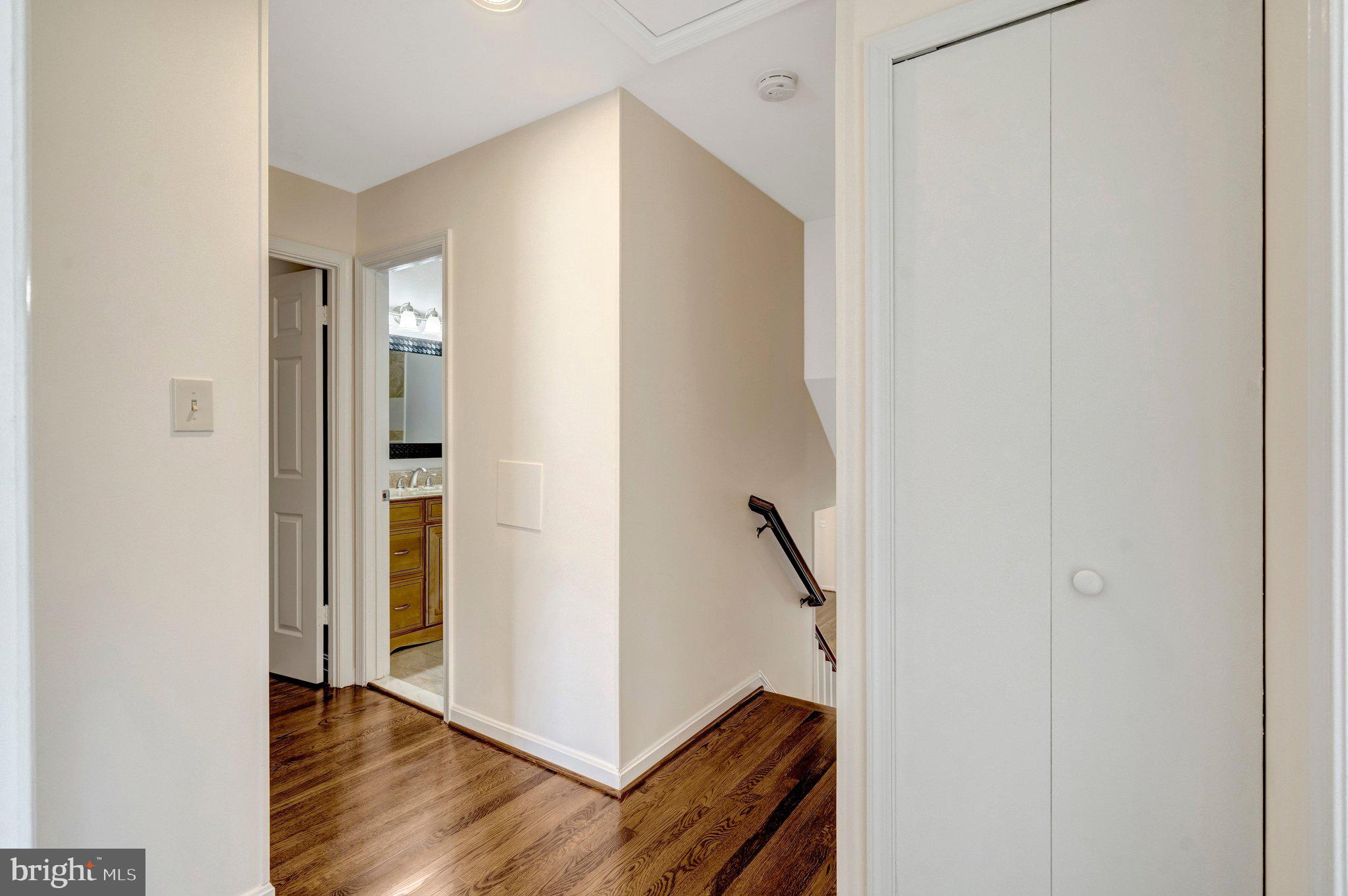 9315 Winbourne Road Burke, VA 22015 - Photo 15 of 51 an entryway with wooden floor and a hallway