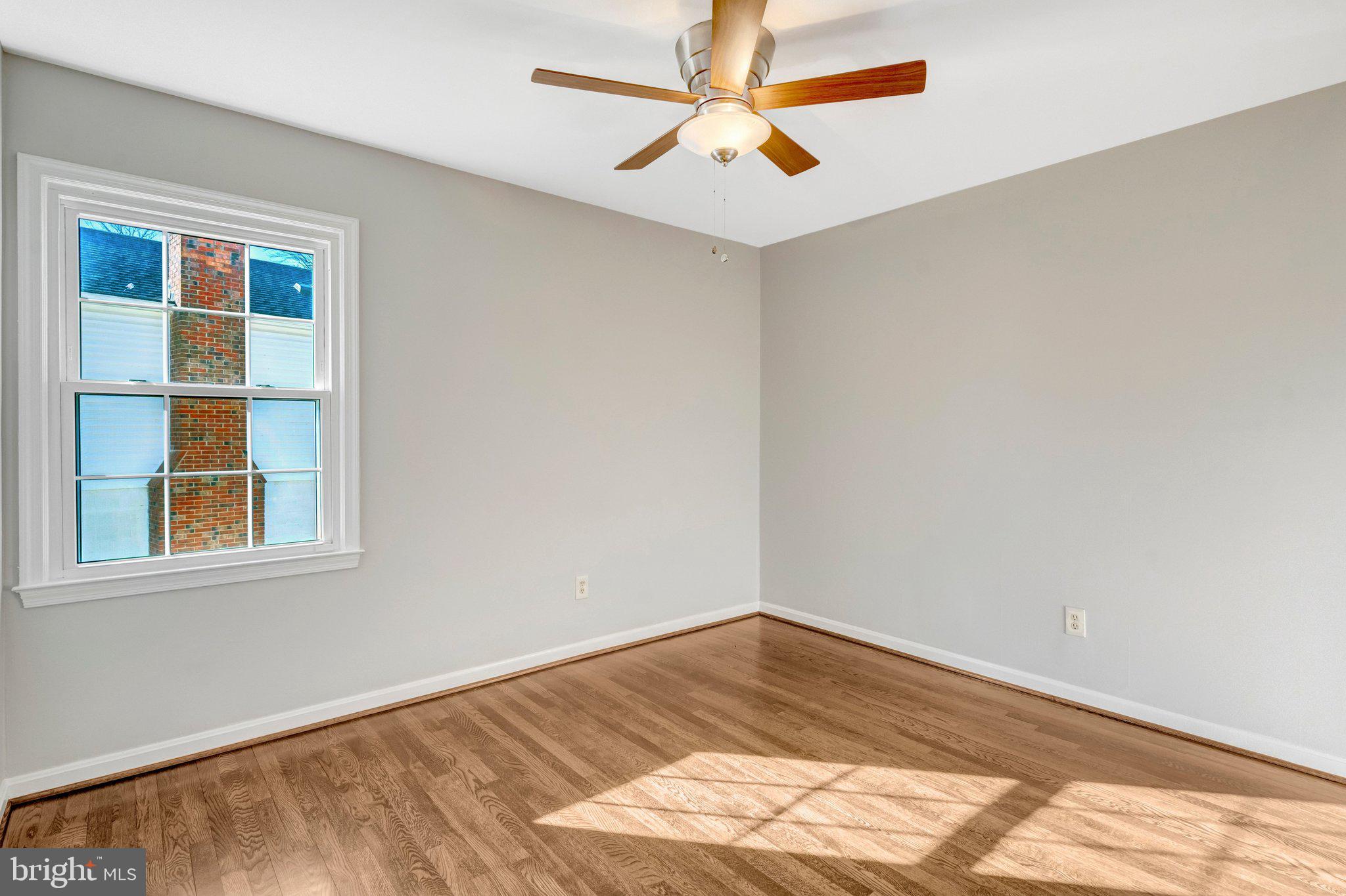 9315 Winbourne Road Burke, VA 22015 - Photo 20 of 51 a view of empty room with wooden floor and fan
