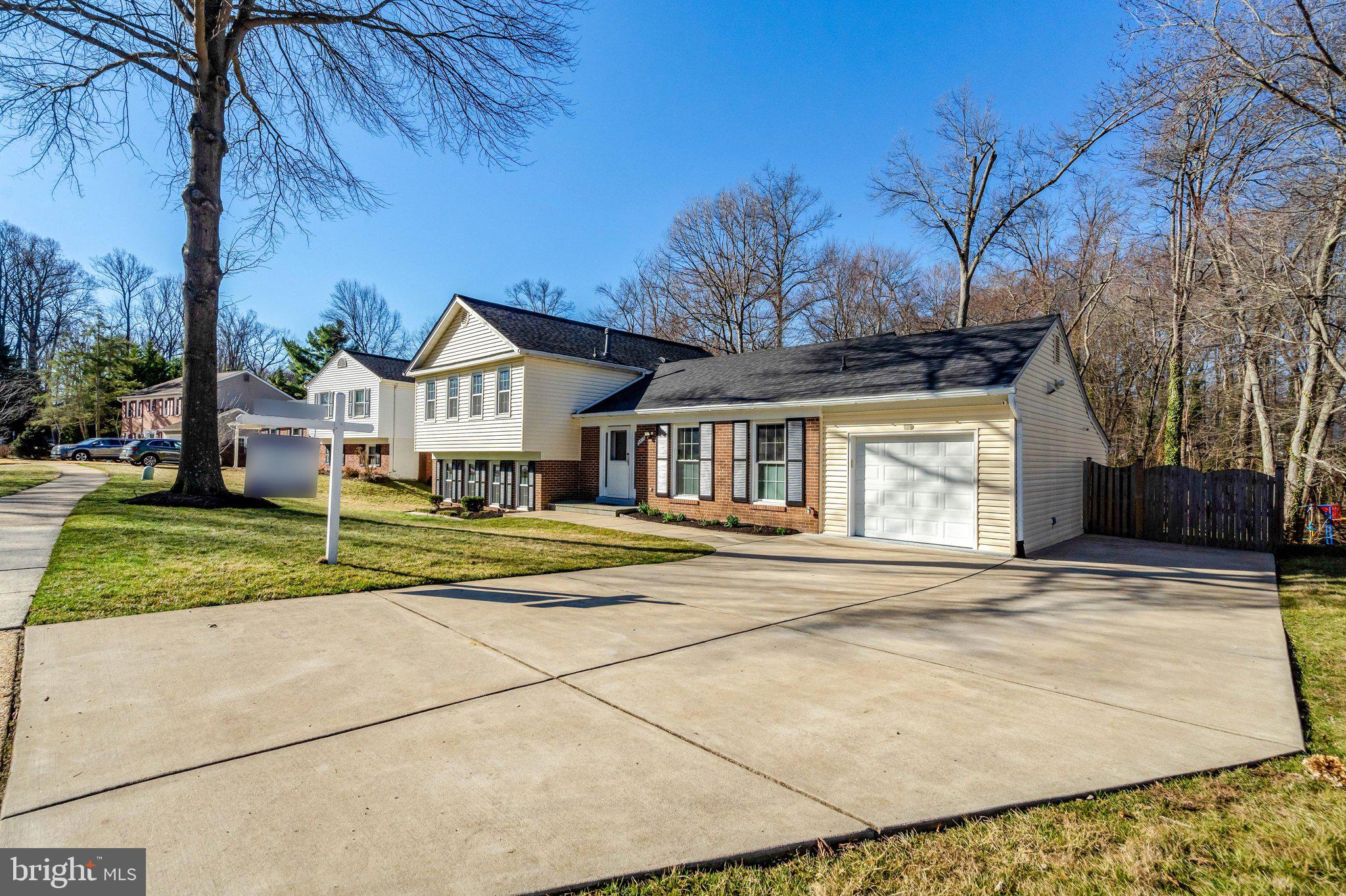 9315 Winbourne Road Burke, VA 22015 - Photo 2 of 51 a front view of a house with a yard and garage