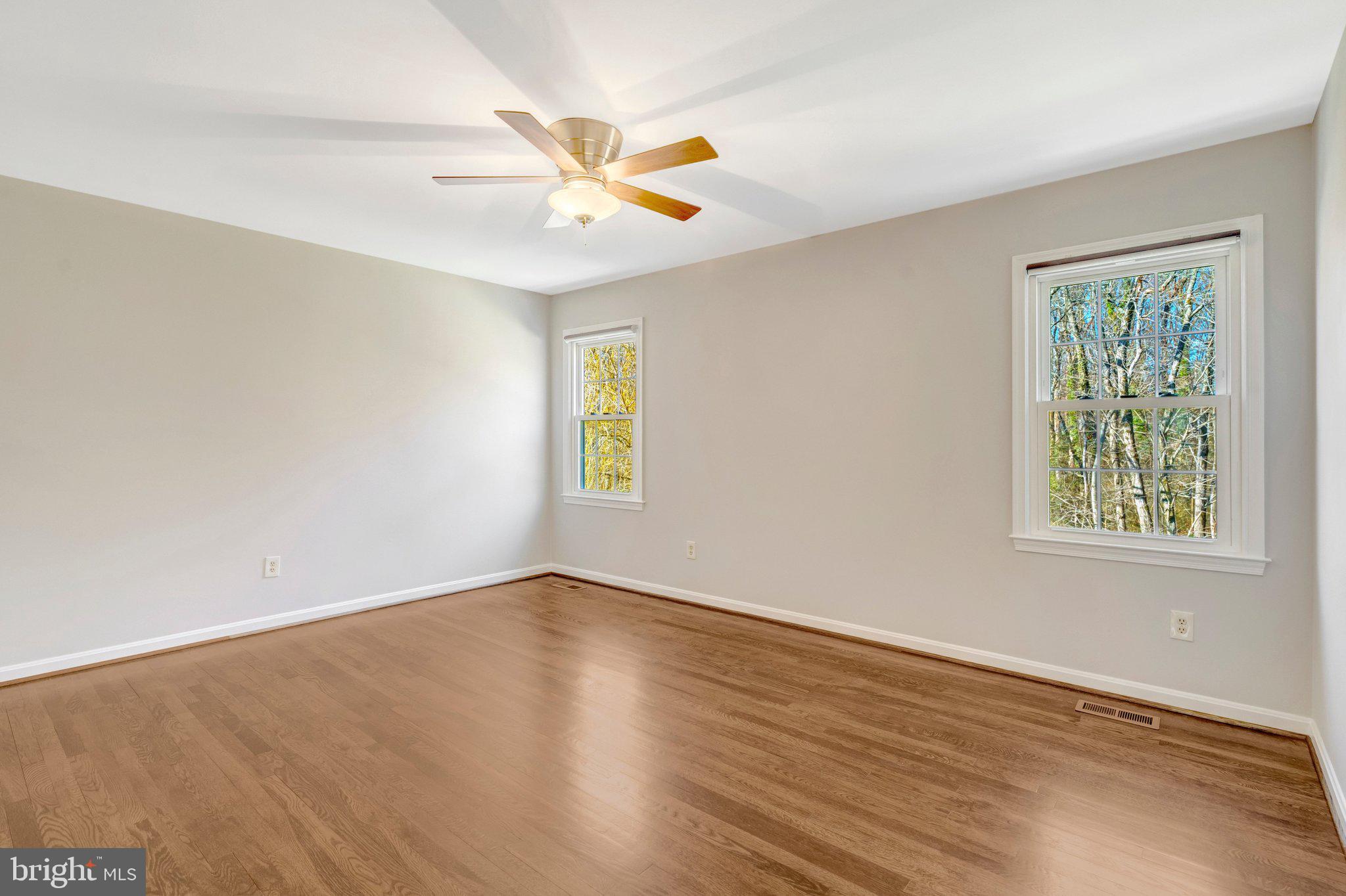 9315 Winbourne Road Burke, VA 22015 - Photo 23 of 51 a view of an empty room with wooden floor and a window
