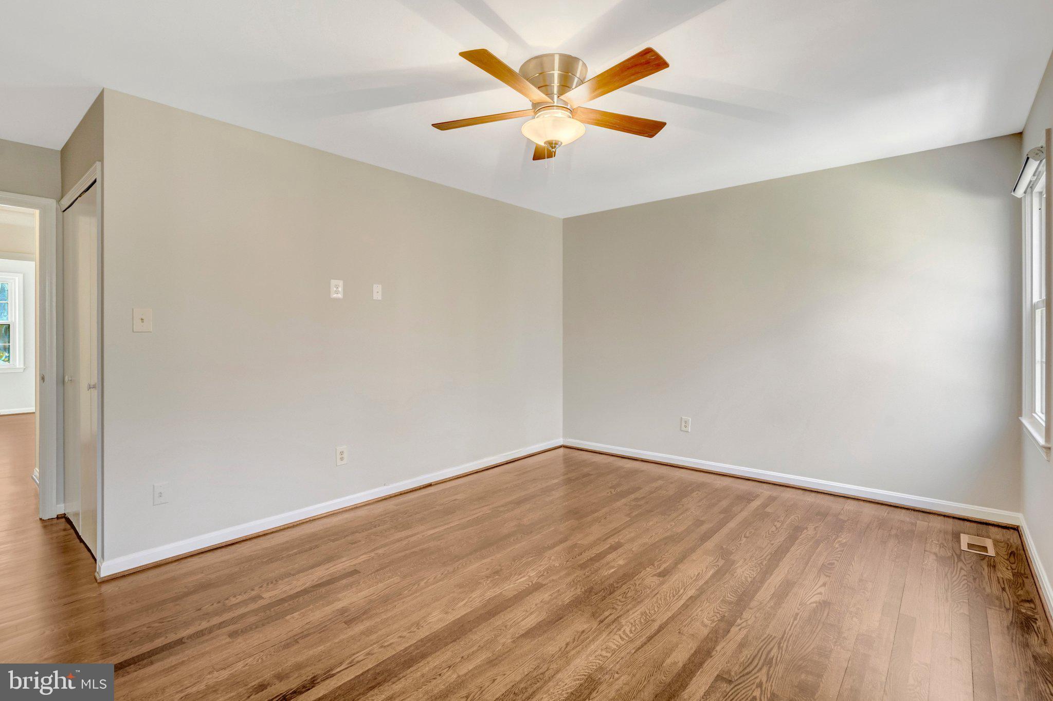 9315 Winbourne Road Burke, VA 22015 - Photo 24 of 51 an empty room with wooden floor and a ceiling fan