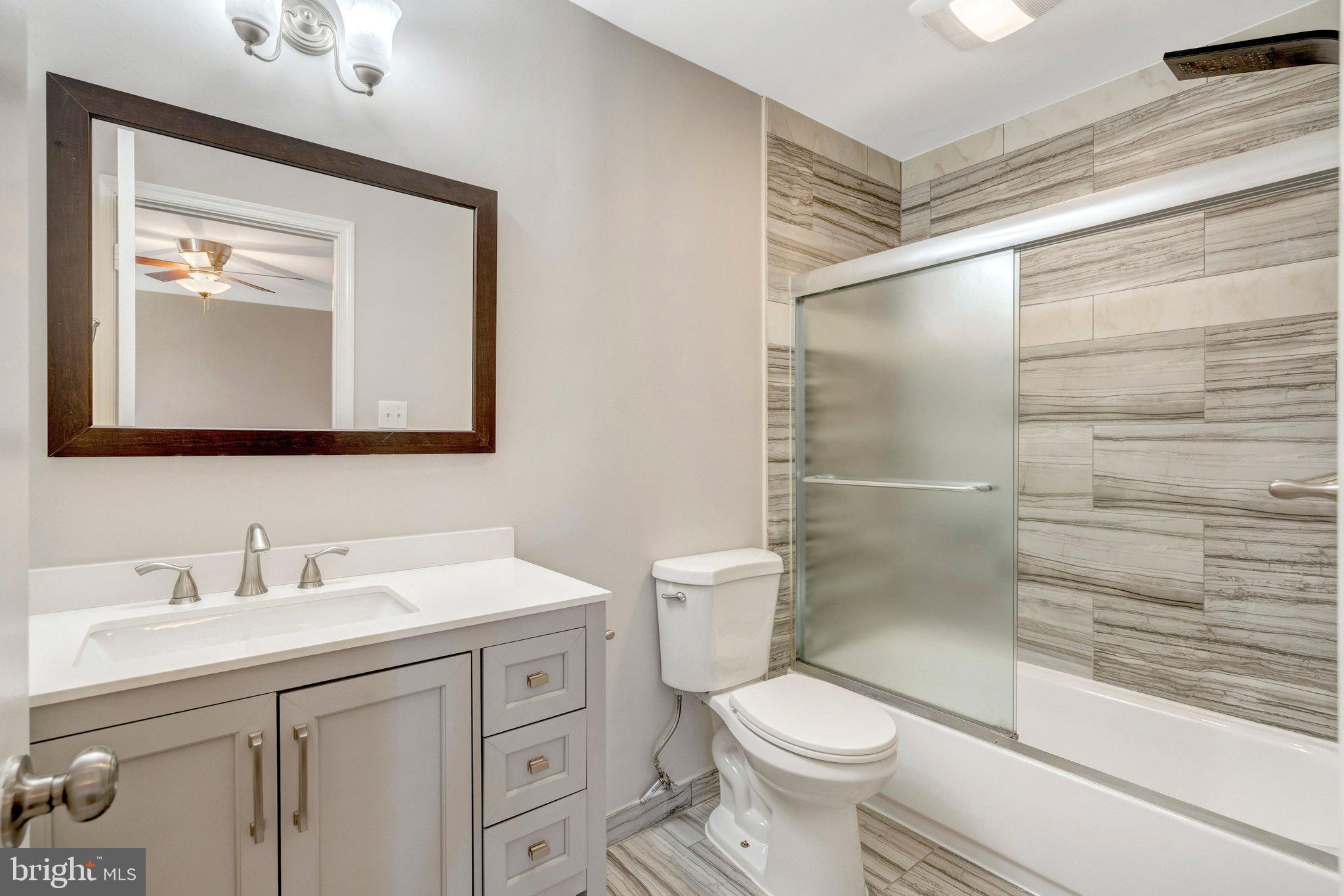 9315 Winbourne Road Burke, VA 22015 - Photo 26 of 51 a bathroom with a toilet sink and a shower