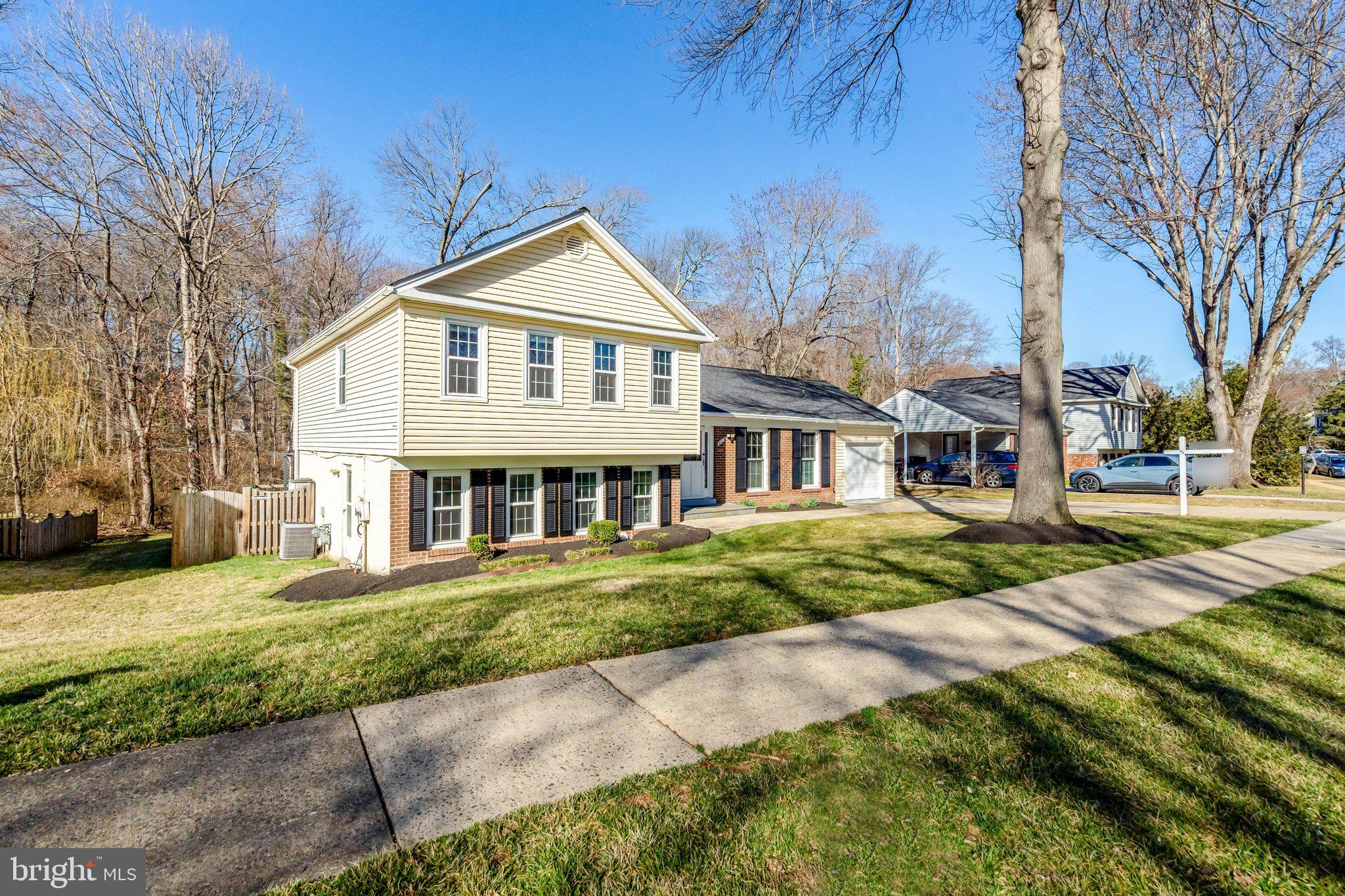 9315 Winbourne Road Burke, VA 22015 - Photo 3 of 51 a front view of a house with a yard