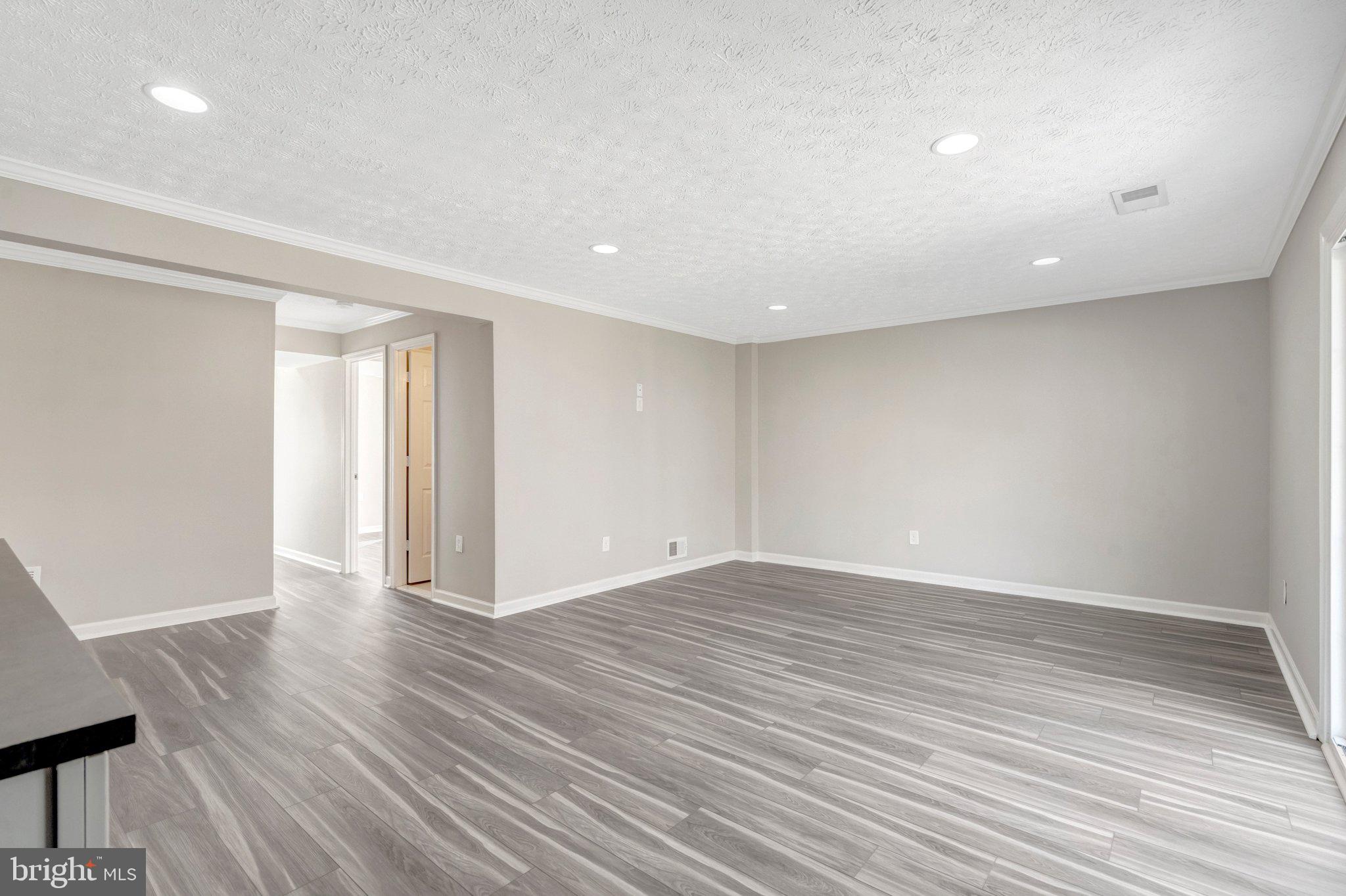 9315 Winbourne Road Burke, VA 22015 - Photo 31 of 51 a view of an empty room with wooden floor and a window