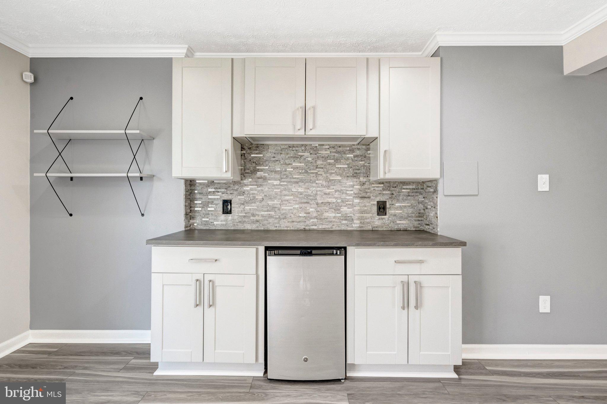 9315 Winbourne Road Burke, VA 22015 - Photo 32 of 51 a kitchen with stainless steel appliances granite countertop a sink and cabinets
