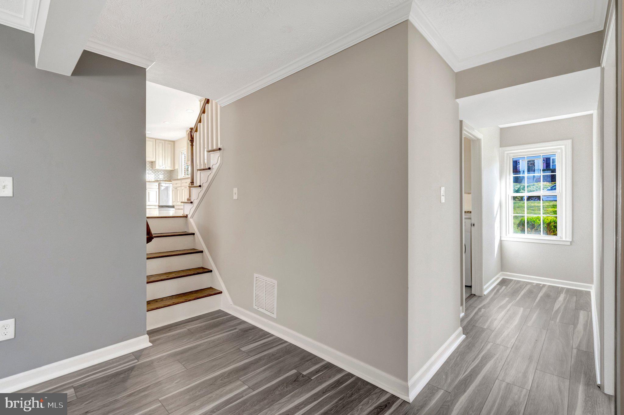 9315 Winbourne Road Burke, VA 22015 - Photo 33 of 51 a view of a hallway with wooden floor and entryway