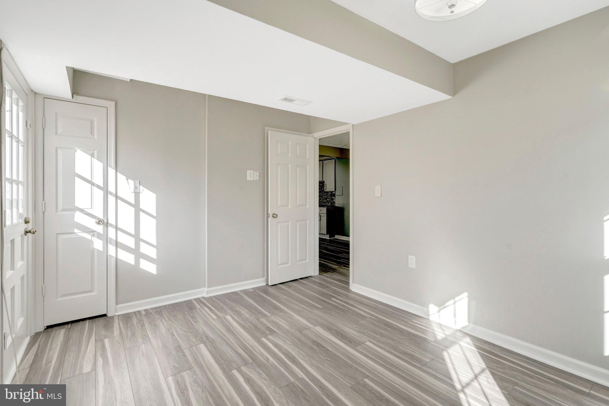 9315 Winbourne Road Burke, VA 22015 - Photo 37 of 51 a view of empty room with wooden floor and fan