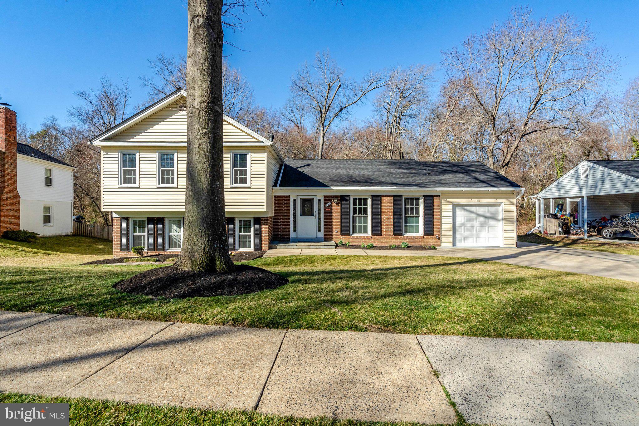 9315 Winbourne Road Burke, VA 22015 - Photo 4 of 51 a front view of a house with a yard