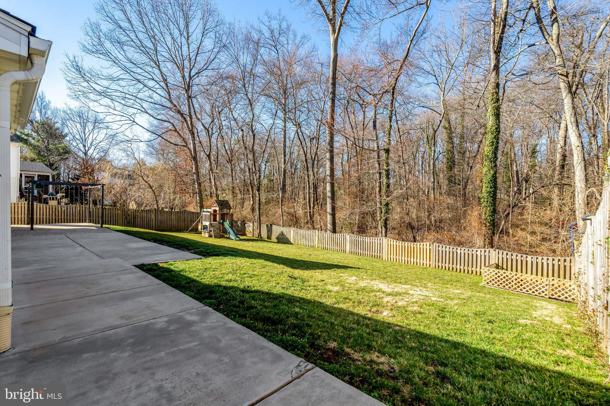 9315 Winbourne Road Burke, VA 22015 - Photo 50 of 51 a view of a swimming pool with a yard and trees