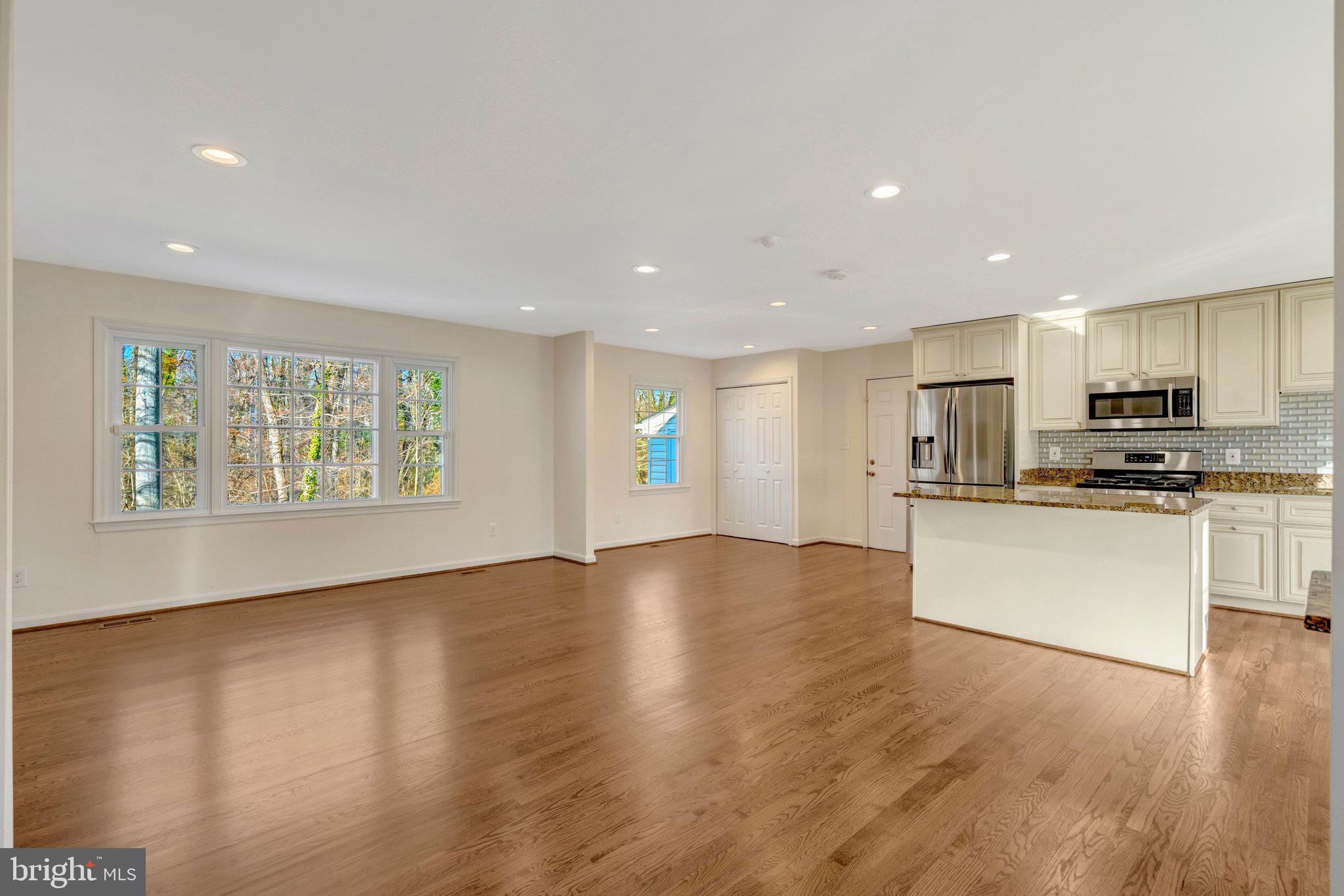 9315 Winbourne Road Burke, VA 22015 - Photo 6 of 51 a view of an empty room with kitchen appliances and a window