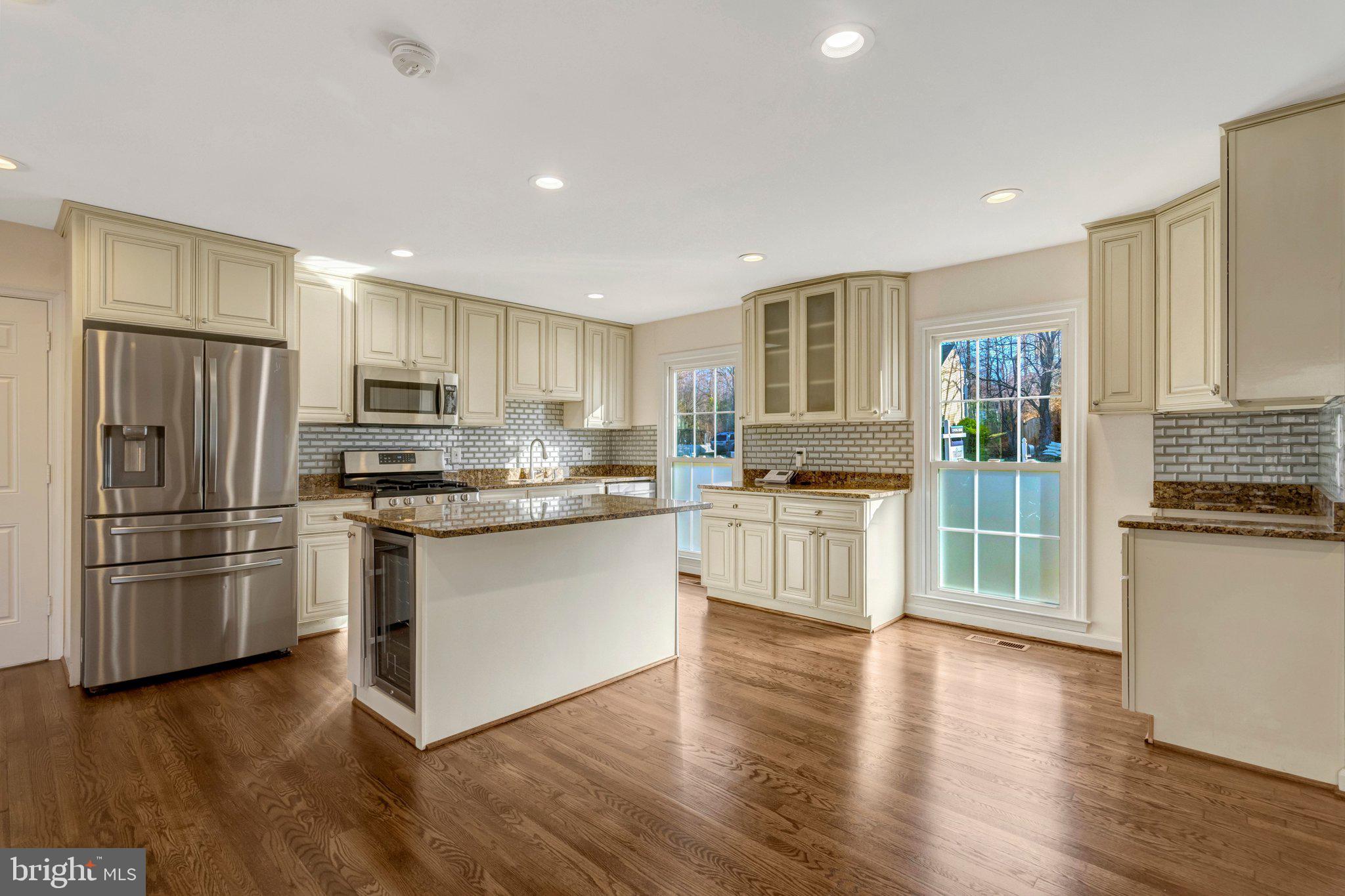 9315 Winbourne Road Burke, VA 22015 - Photo 7 of 51 a kitchen with a refrigerator cabinets and wooden floors