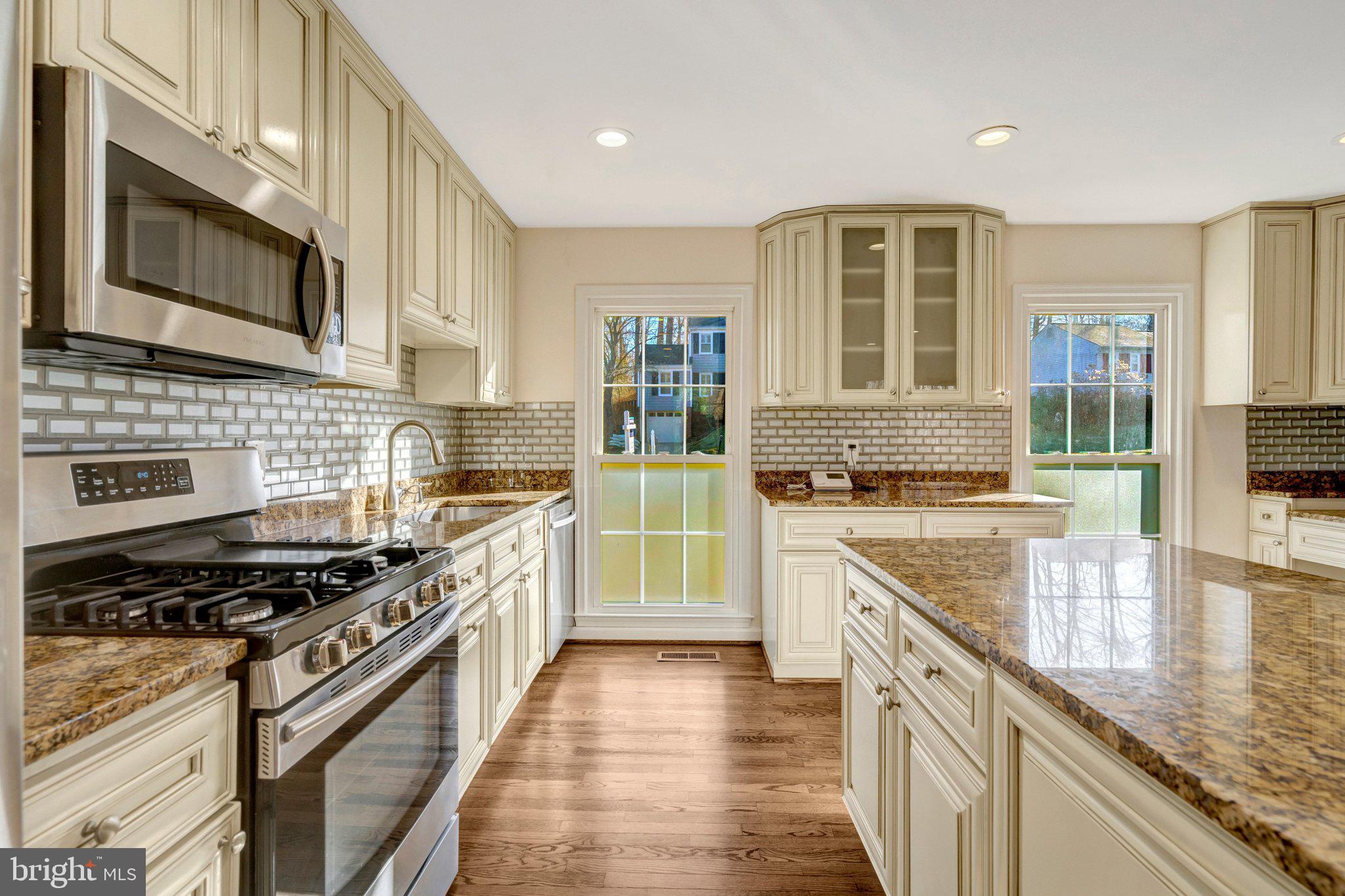 9315 Winbourne Road Burke, VA 22015 - Photo 10 of 51 a kitchen with stainless steel appliances granite countertop a stove and a sink