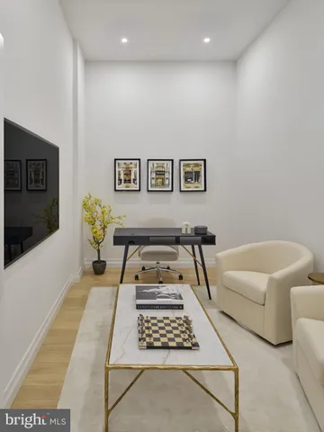 a bedroom with furniture and a rug