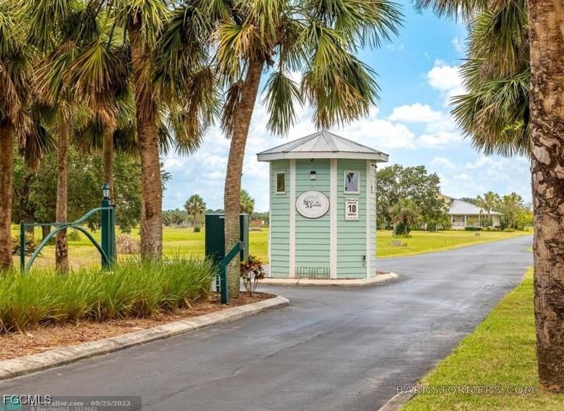 1520 Lindbergh Loop LaBelle, FL 33935 - Photo 5 of 16 a view of a house with palm trees and a small yard