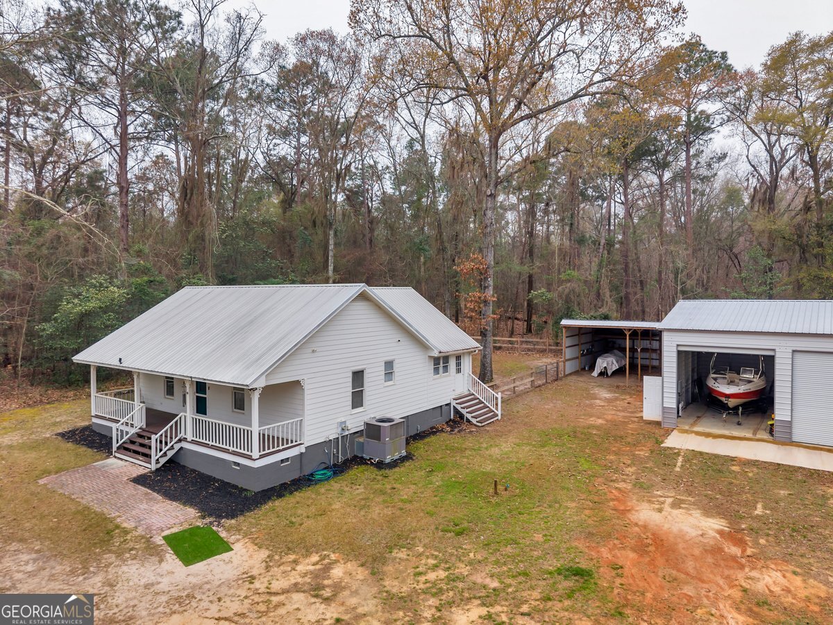 418 Flintside Drive Cobb, GA 31735 - Photo 1 of 45 an aerial view of a house with swimming pool and sitting area