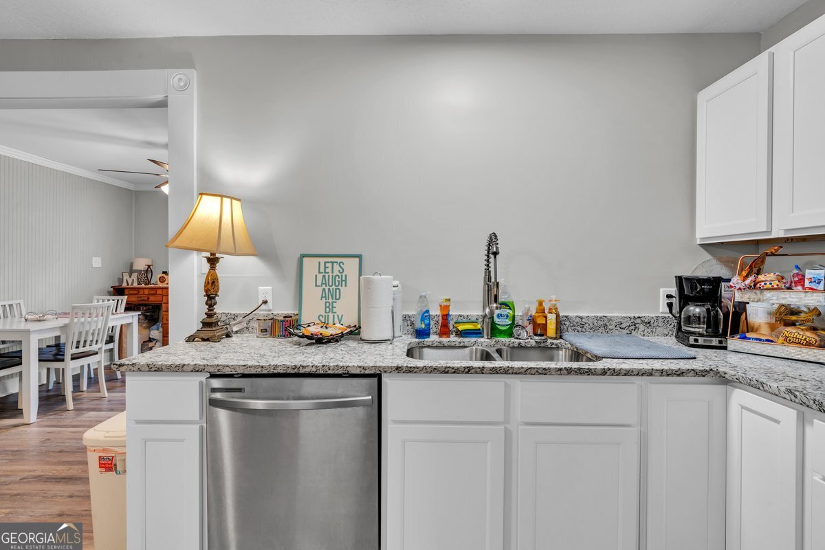 418 Flintside Drive Cobb, GA 31735 - Photo 13 of 45 a kitchen with sink and a white cabinets