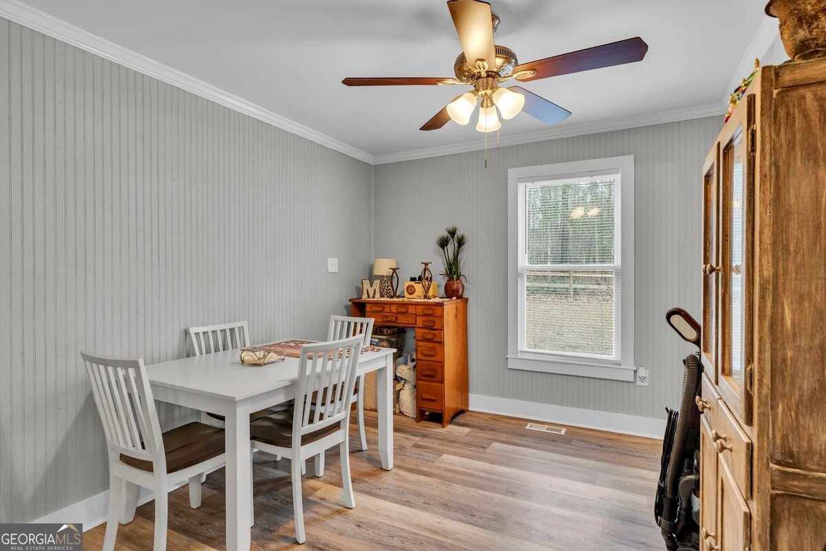 418 Flintside Drive Cobb, GA 31735 - Photo 14 of 45 a dining room with furniture a chandelier and wooden floor