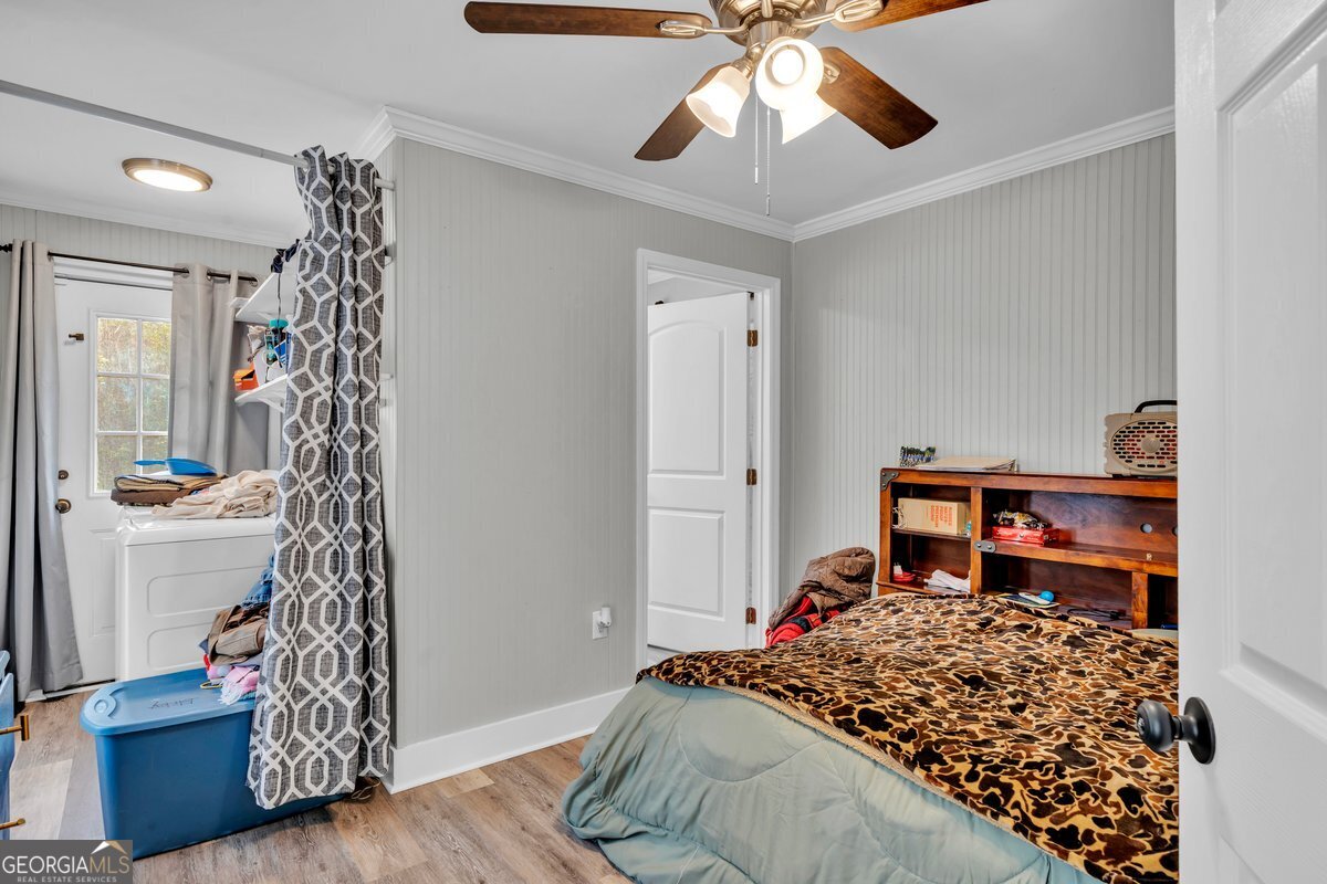 418 Flintside Drive Cobb, GA 31735 - Photo 16 of 45 a bedroom with a bed and a chandelier