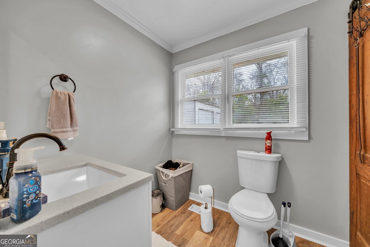 418 Flintside Drive Cobb, GA 31735 - Photo 18 of 45 a bathroom with a toilet sink and window