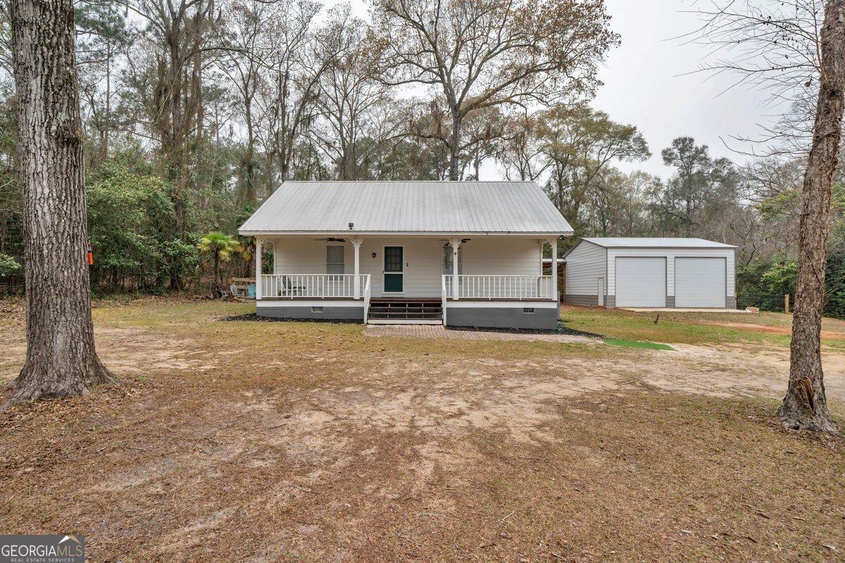 418 Flintside Drive Cobb, GA 31735 - Photo 2 of 45 a house with trees in the background