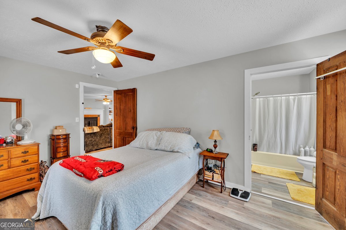 418 Flintside Drive Cobb, GA 31735 - Photo 21 of 45 a bedroom with a bed and a chandelier